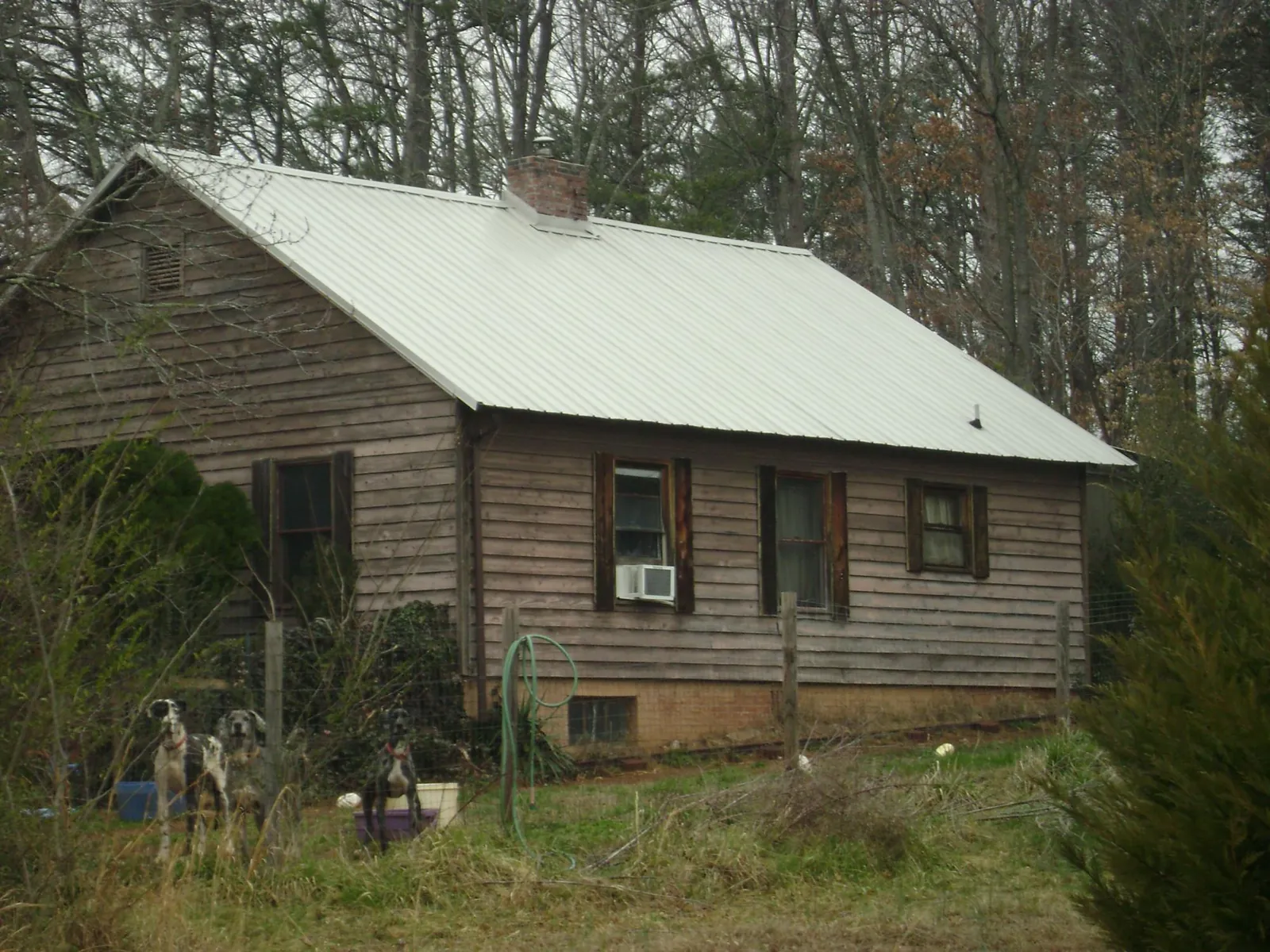White metal roof on an old wood sided farmhouse, from a Metal Roof Installation job in Box Springs